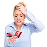 Picture of stressed woman holding credit cards related to savings