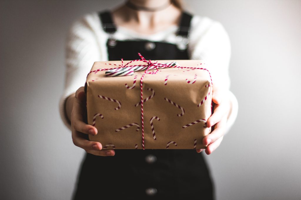 Picture of woman holding gift related to debt