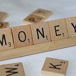 Picture of money spelled out in scrabble board pieces for savings