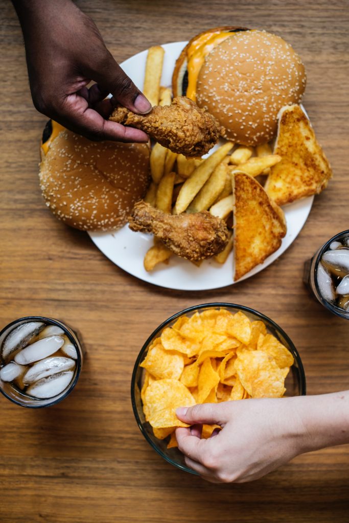 image of plate of burgers, fries, chips, and sodas r/t a healthy lifestyle.