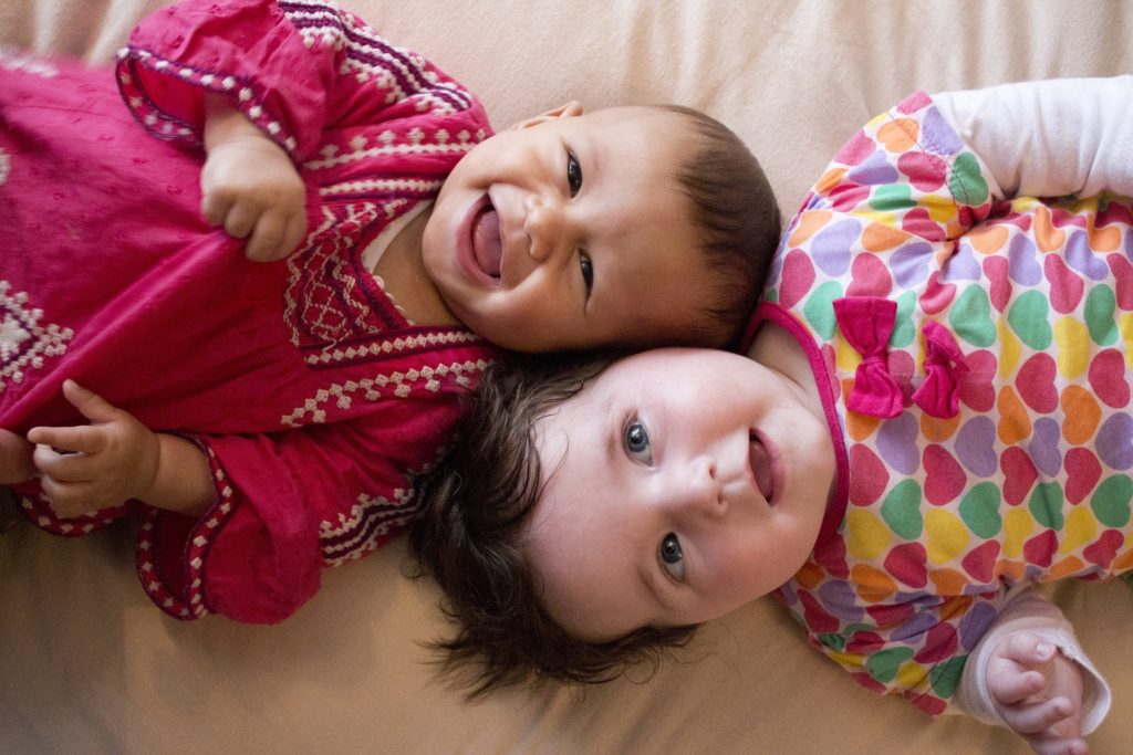 image of 2 babies laughing r/t a healthy lifestyle.