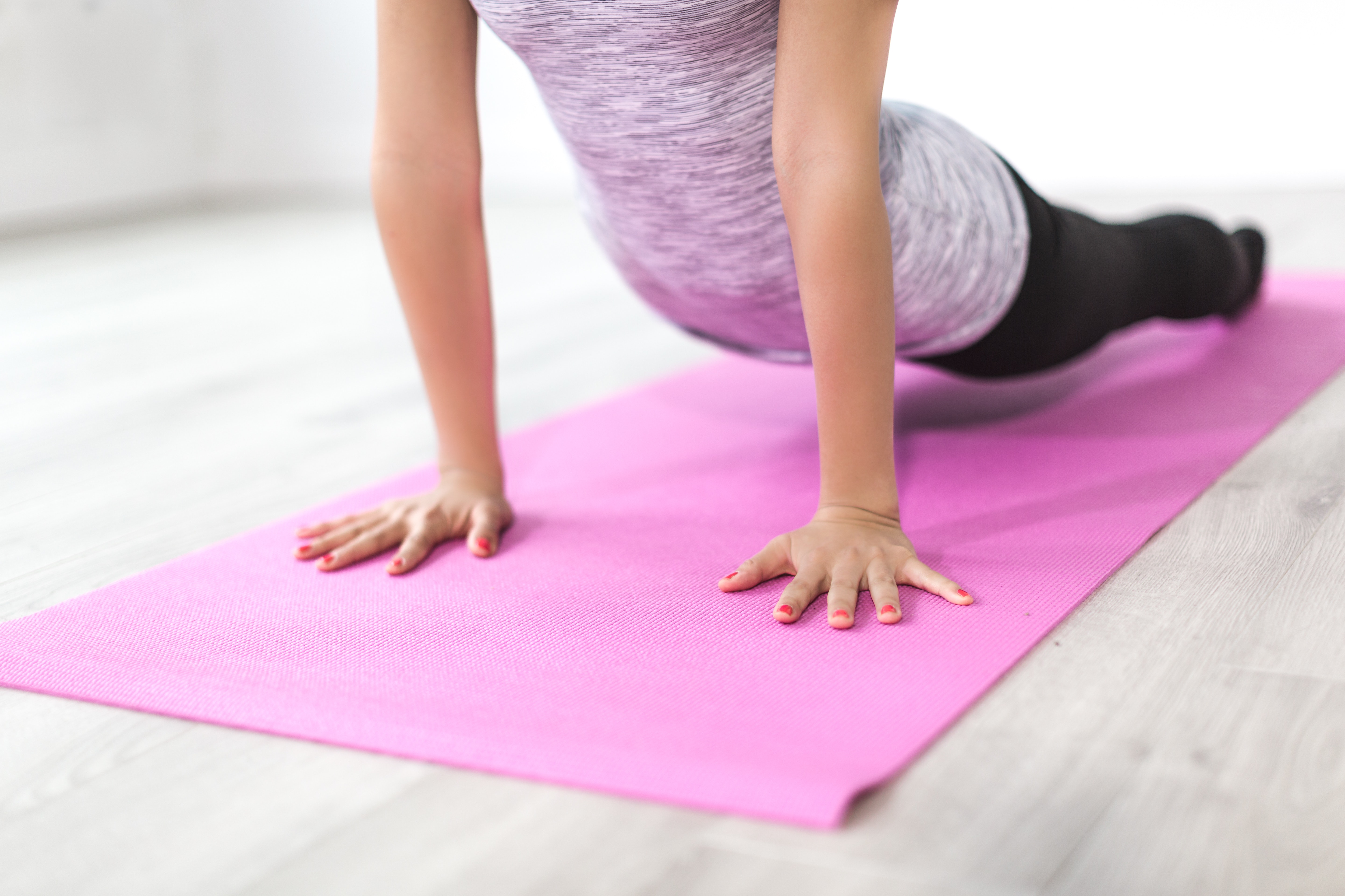 partial image of woman on doing yoga pose on a yoga mat r/t healthy lifestyle