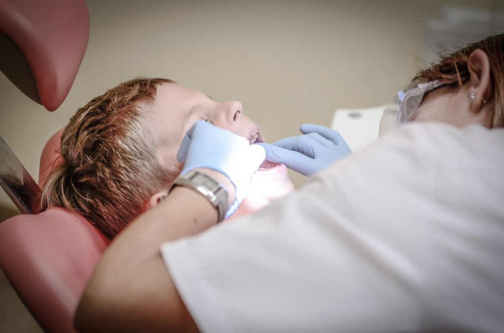 picture of a boy in dental chair having a check-up r/t healthy lifestyle.