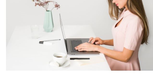 Woman at desk on laptop r/t financial health