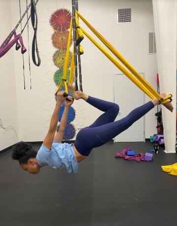 Mia doing aerial yoga r/t self-care.