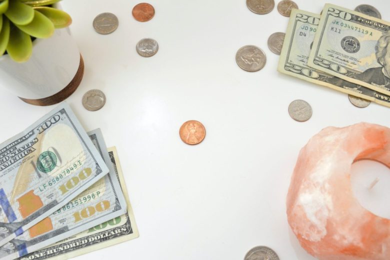 close-up of money and a donut on a table r/t single mom