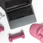 aerial view of laptop and dumbells r/t money