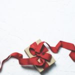 aerial view of a package with large red bow r/t holiday season