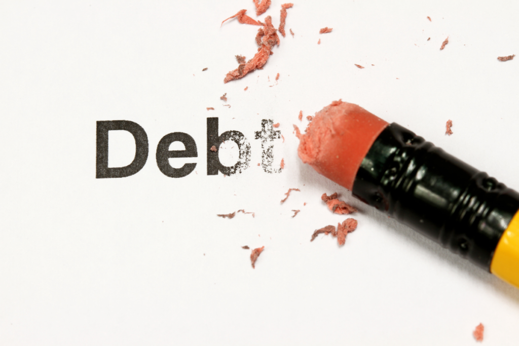 closeup pencil erasing the word debt r/t ways to save money