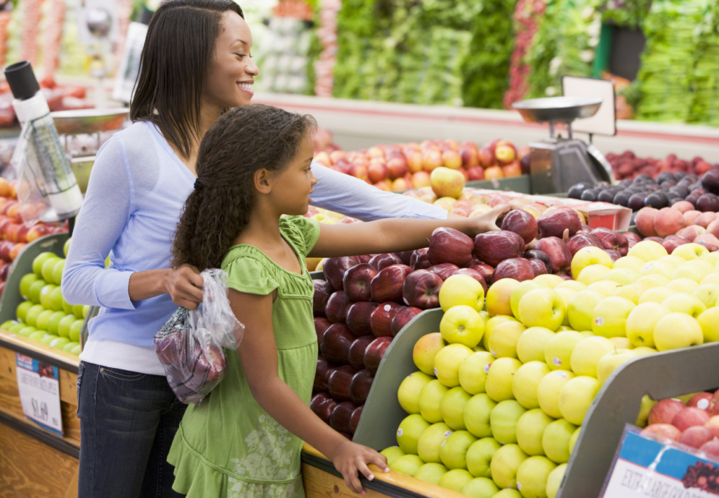 Mom and daughter buying apples r/t teaching kids about money