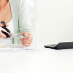 Close up of woman cutting a credit card