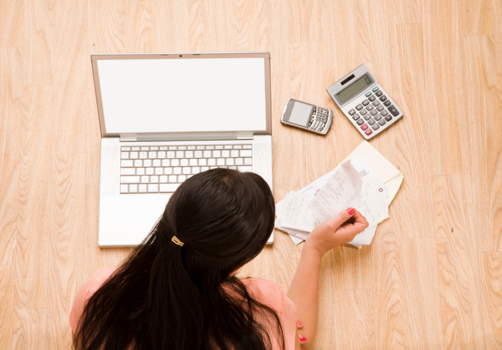 Aerial view of women with computer and bills r/t fresh start